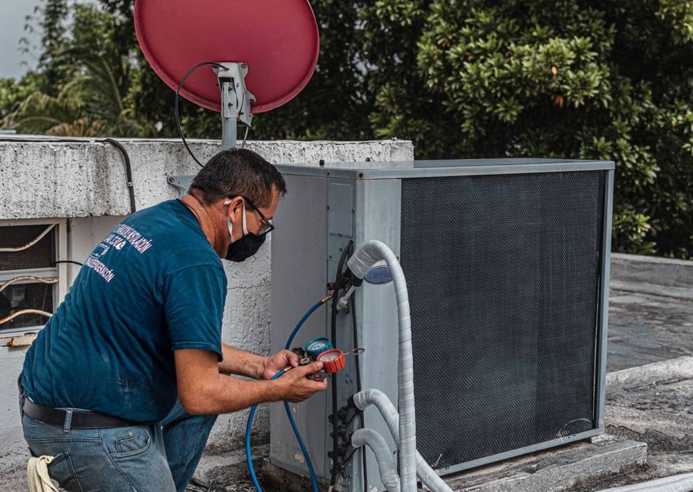 Technician servicing an air conditioning unit